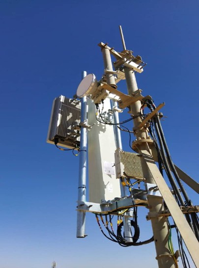 Telecommunications tower equipment under blue sky